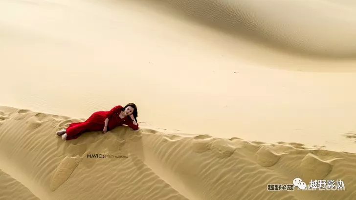 Aerial female driver driving a Wrangler across the Kubuqi Desert