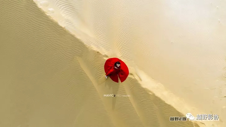 Aerial female driver driving a Wrangler across the Kubuqi Desert