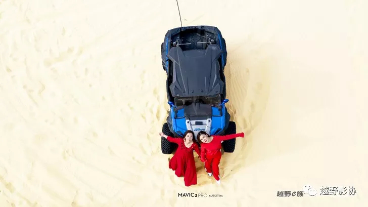 Aerial female driver driving a Wrangler across the Kubuqi Desert